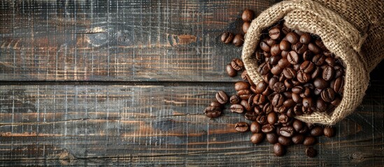Poster - Coffee beans roasted and placed in a burlap sack on a wooden rustic backdrop with ample copy space image