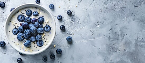 Aufkleber - Blue yogurt smoothie bowl with blueberries and coconut flour on a light concrete surface background providing space for additional image elements