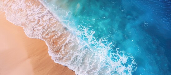 Poster - Aerial view of a sandy beach by the ocean with a transparent blue and turquoise water surface offering a horizontal background with copy space image