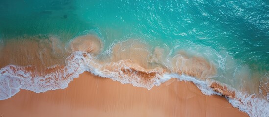 Poster - A beautiful sandy beach with turquoise water seen from a drone offers a copy space image