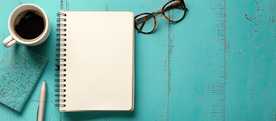 Poster - Top down perspective of a notebook on a table with a blank space for text or images. Creative banner. Copyspace image