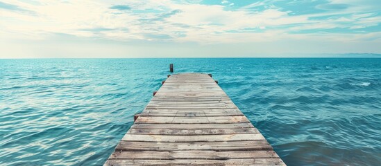 Fototapete - Concrete pier offers picturesque view of tranquil sea with copy space image