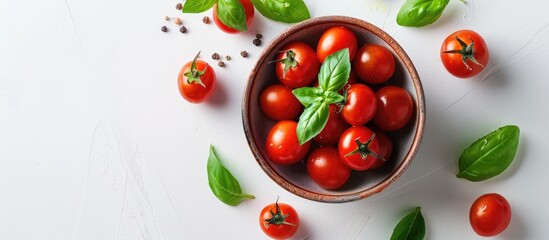 Poster - Top view of cherry tomatoes green basil and tomato sauce in a bowl on a white background with copy space image