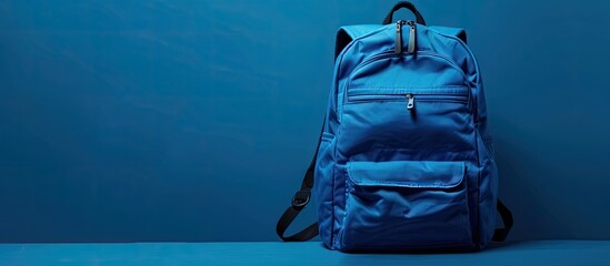 Poster - Blue backpack with ample copy space image for personalization