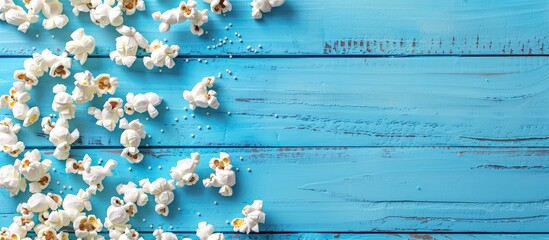 Sticker - A blue wooden surface holding popcorn with room for text in the image. Creative banner. Copyspace image