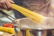 © Vlad - Cooking Pasta. Man Preparing Spaghetti in Boiling Water in Kitchen