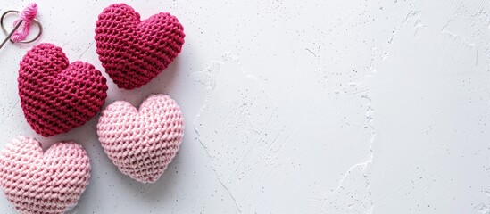 Aufkleber - Top view of amigurumi pink hearts crocheted with a hook on a white backdrop ideal for a Valentine s banner showcasing a copy space image