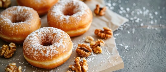 Canvas Print - Close up view of delicious donuts and nuts on a sheet of baking paper with copy space image