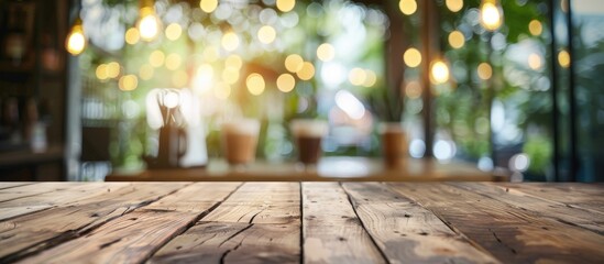 Poster - Blurry background in a cafe or coffee shop setting featuring a wooden table with bokeh effect perfect as a copy space image for showcasing products