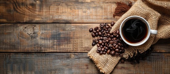 Leinwandbilder - Top view of a coffee cup and beans on a wooden table with background suitable for additional text or graphics commonly known as copy space image