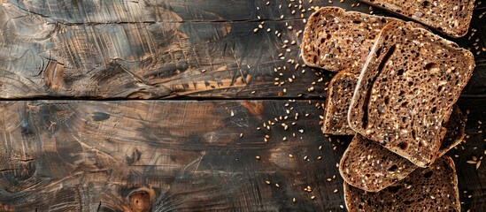 Poster - Chunks of seeded brown bread are sliced on a rustic wooden surface providing a picturesque backdrop for a copy space image
