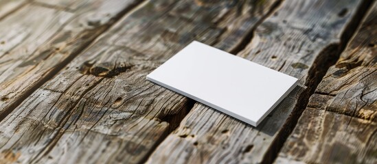 Poster - Close up shot of a white business card on a wooden surface with ample copy space suitable for various business purposes