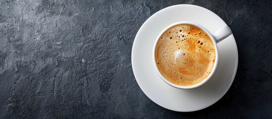 Aufkleber - Coffee cup with frothy foam on a white saucer displayed against a dark backdrop with copy space image