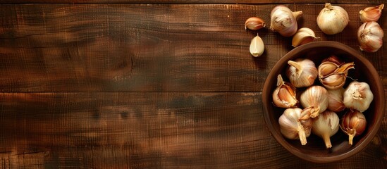 Poster - A bowl filled with garlic and onion on a wooden surface with copy space image available