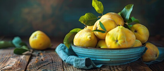 Poster - Close up of delicious ripe quinces in a bowl on a wooden table with copy space image available