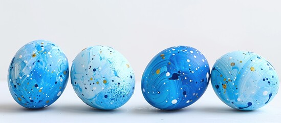 Fototapete - Blue chicken eggs painted with abstract designs using strainers showcasing them against a blank background for a copy space image