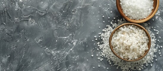 Poster - Top down view of mineral bath salt on a grey background with ample copy space for text or images