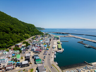 Wall Mural - Rausu, Hokkaido: Aerial drone view of the Rausu town and harbor in the Shiretoko peninsula in Hokkaido in summer in Japan