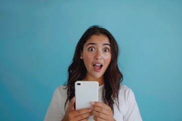 Wall Mural - Surprised woman holding smartphone