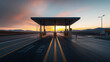 © Natalia - Highway toll booth at sunset with multiple lanes and distant hills in the background under a partly cloudy sky with vibrant orange and pink hues.