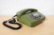 © kittyfly - Old green Rotary Telephone with Disc Dial, Dialing on retro phone reciver down, Connecting with Past, calls helpline, psychological support
