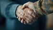 ©  Jovaduplex - This image shows a close-up of two elderly individuals warmly shaking hands, one in a grey sweater and the other in a camouflage jacket, representing connection and unity.