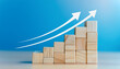 © hardvicore - Wooden cubes chart, steps and white rising up arrow on blue background. Business growth concept