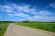© Joachim Beauvilain - Petite route de campagne dans un paysage normand avec ciel et champ au grand angle