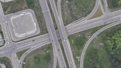 Wall Mural - Aerial footage of a highway interchange with looping roads and green spaces in Cambridge, Canada