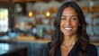 © aicandy - A close-up portrait of a smiling woman with dark hair in a modern cafe setting with warm lighting and a blurred background showcasing shelves and kitchen items