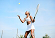 © peopleimages.com - Sky, tennis player or black woman serving in sports for match, workout or exercise on outdoor court. Hobby, throw ball or girl athlete with racket ready for playing, fitness training or practice game