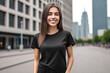 © drimerz - portrait of a smiling woman wearing  blank black t-shirt mockup on blurred morning city background