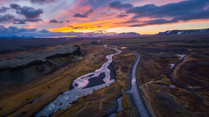 Wall Mural - Aerial View of a Winding Road and River in Iceland During Sunset