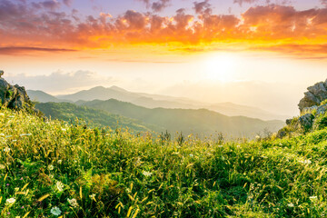 Wall Mural - sceniv view from a top of a rocky mountain to amazing highland landscape with valley, peaks of mountains and beautiful cloudy sunset or sunrise