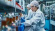 © Pornarun - A female worker in a sterile environment inspecting bottles on an assembly line.
