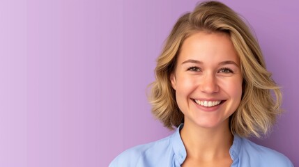 Wall Mural - A woman with blonde hair and a blue shirt is smiling. She is looking at the camera. The background is purple