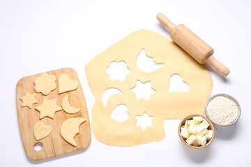 Wall Mural - Raw dough, uncooked cookies, flour, butter, rolling pin and board isolated on white, above view