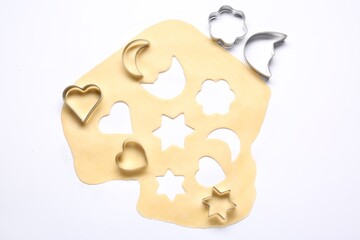 Wall Mural - Raw dough and cookie cutters isolated on white, top view