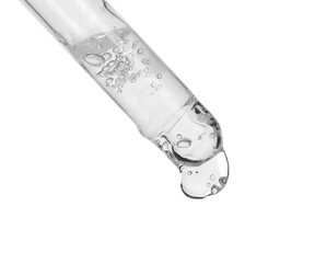 Dripping cosmetic serum from pipette on white background