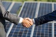 © Igor - Businessmen sealing a solar panel project deal with a handshake, highlighting their commitment to green energy