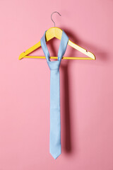 Sticker - Hanger with light blue tie on pink background