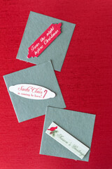 Sticker - three cardboard tags or label with seasonal messages on square green tiles and red paper with metallic surface