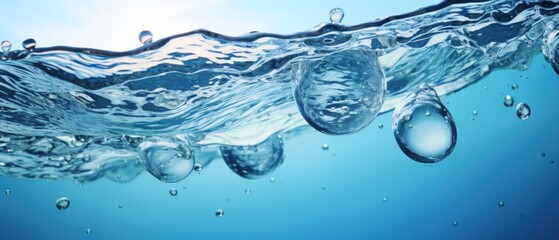 Wall Mural - Water surface with air bubbles. Water texture. Water Drops. Water splash with bubbles on blue background. Copy space for text. Water wave and air bubbles in blue water background. Copy space.