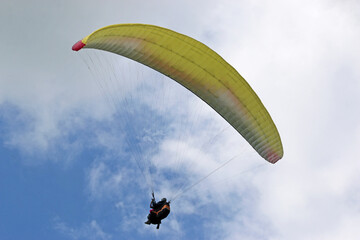 Poster - Tandem Paraglider flying in a cloudy sky	