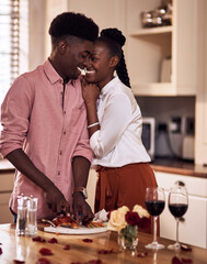 Canvas Print - Home, black couple and happy with wine glass in cooking dinner for support, bonding and roses. Kitchen, relationship and people for anniversary celebration, relax and romantic with meal and alcohol