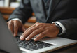 © PixPacks - Closeup of businessman hand typing on laptop computer at office. Business man working on computer device, searching the information, surfing the internet on table at workplace