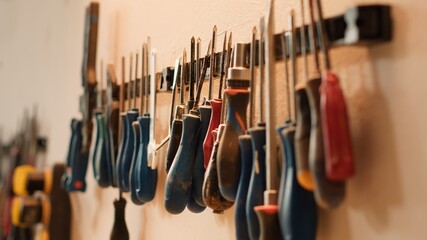 Sticker - Chisels, screwdrivers, wrench and pliers on wall in furniture assembly shop, panning shot. Close up of various woodworking tools on rack in joinery used for working with wood materials