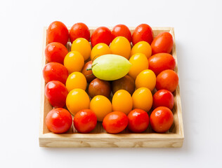 Poster - Close-up of red and yellow cherry tomatoes on rectangular wood plate, South Korea
