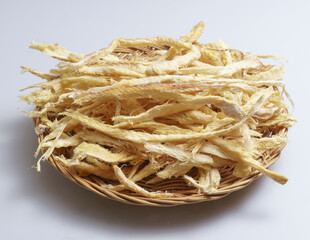 Sticker - Close-up of stacked dried Hwangtae(Dried Pollack) in pieces on bamboo basket, South Korea
