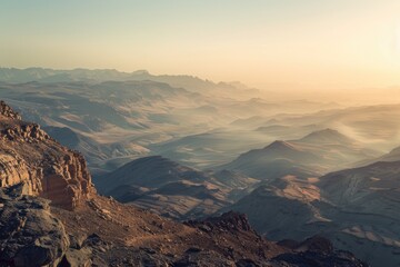 Canvas Print - A scenic view of a mountain range during sunset with warm orange and pink hues